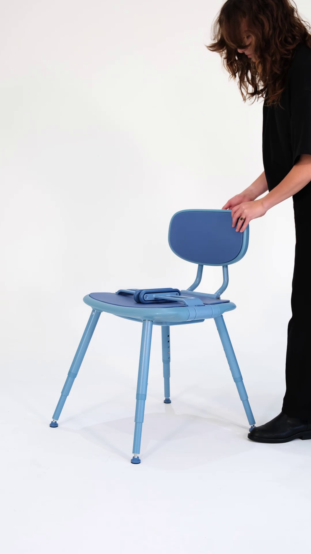 Bondi Blue Chair being set up by woman with brown hair
