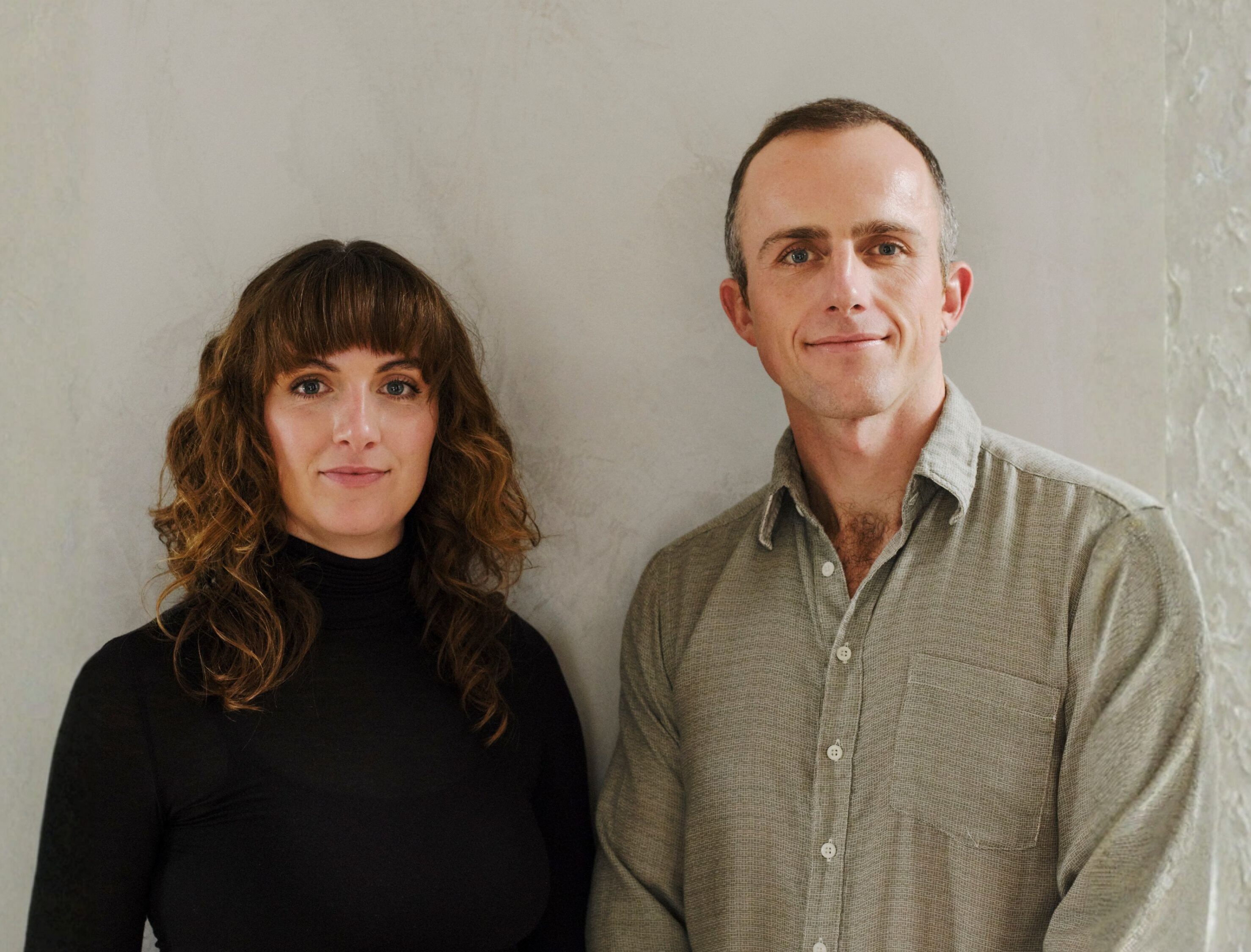 Co-founders Eilish (left) and Samuel (right) stand in front of a neutral background