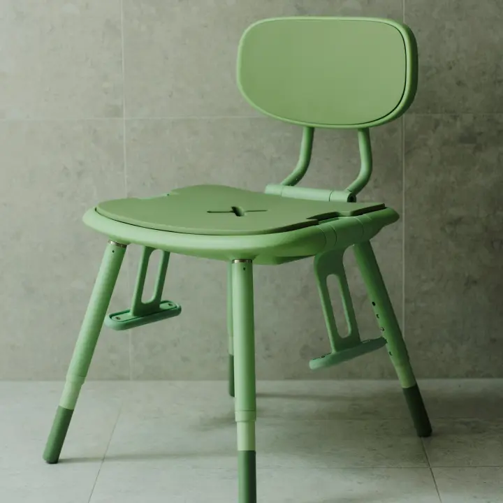 A pastel green Oasis shower chair is positioned with both adjustable armrests down