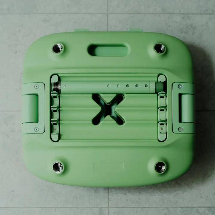 A pastel green Oasis Shower Chair is shown in its packed down form. one telescopic leg is fitted into the storage compartment on the underside of the chair. The chair is folded and packed down, ready for storage or transport